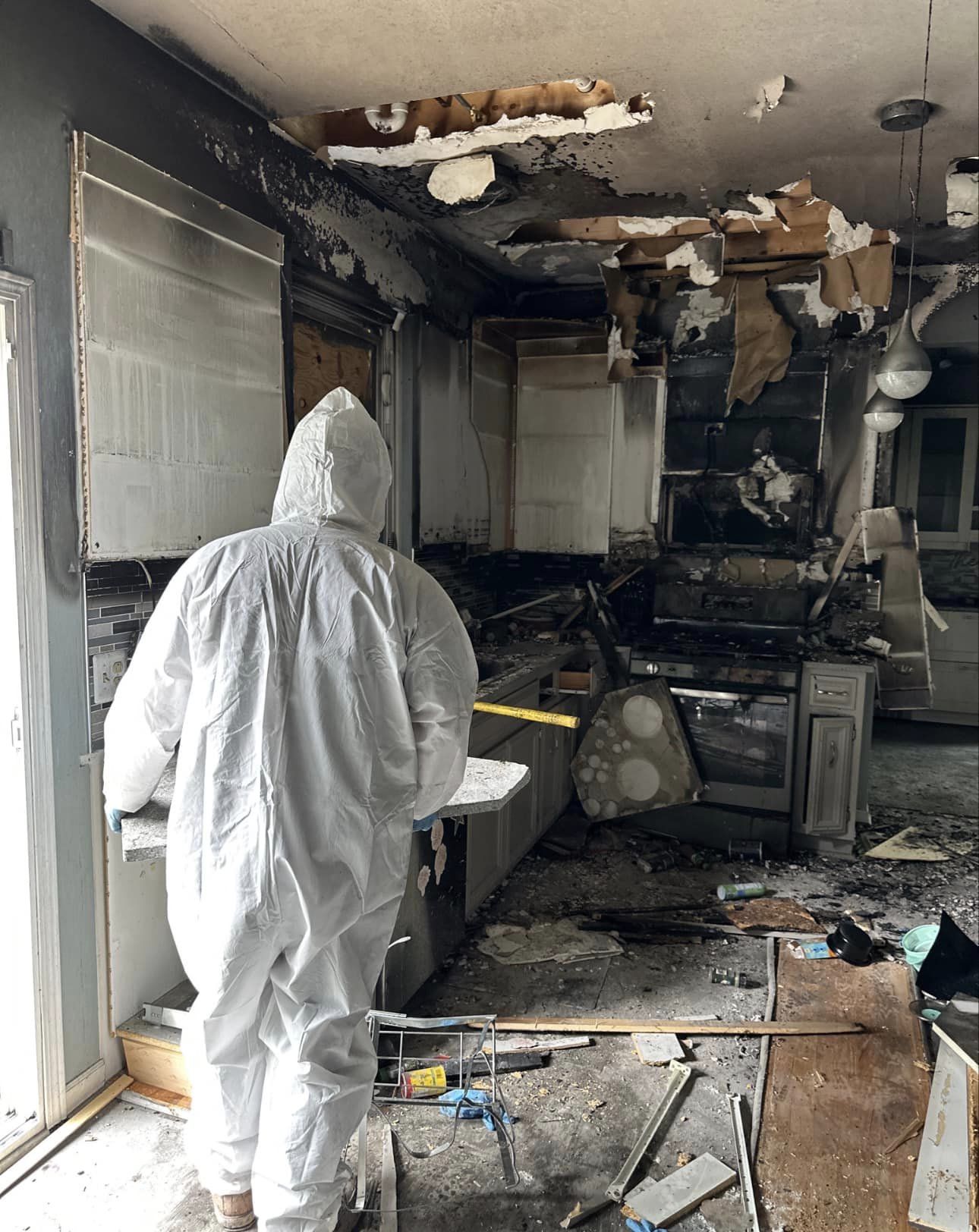 Restoration technician carefully cleaning soot from personal belongings after a fire