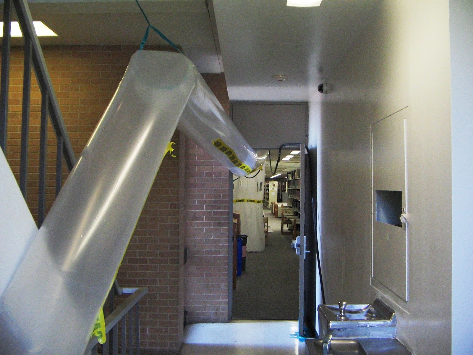 Mold remediation team setting up containment barriers in a US home