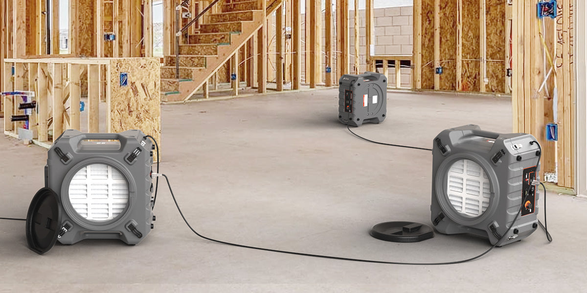 Odor elimination specialist operating air scrubbing equipment in smoke-damaged room