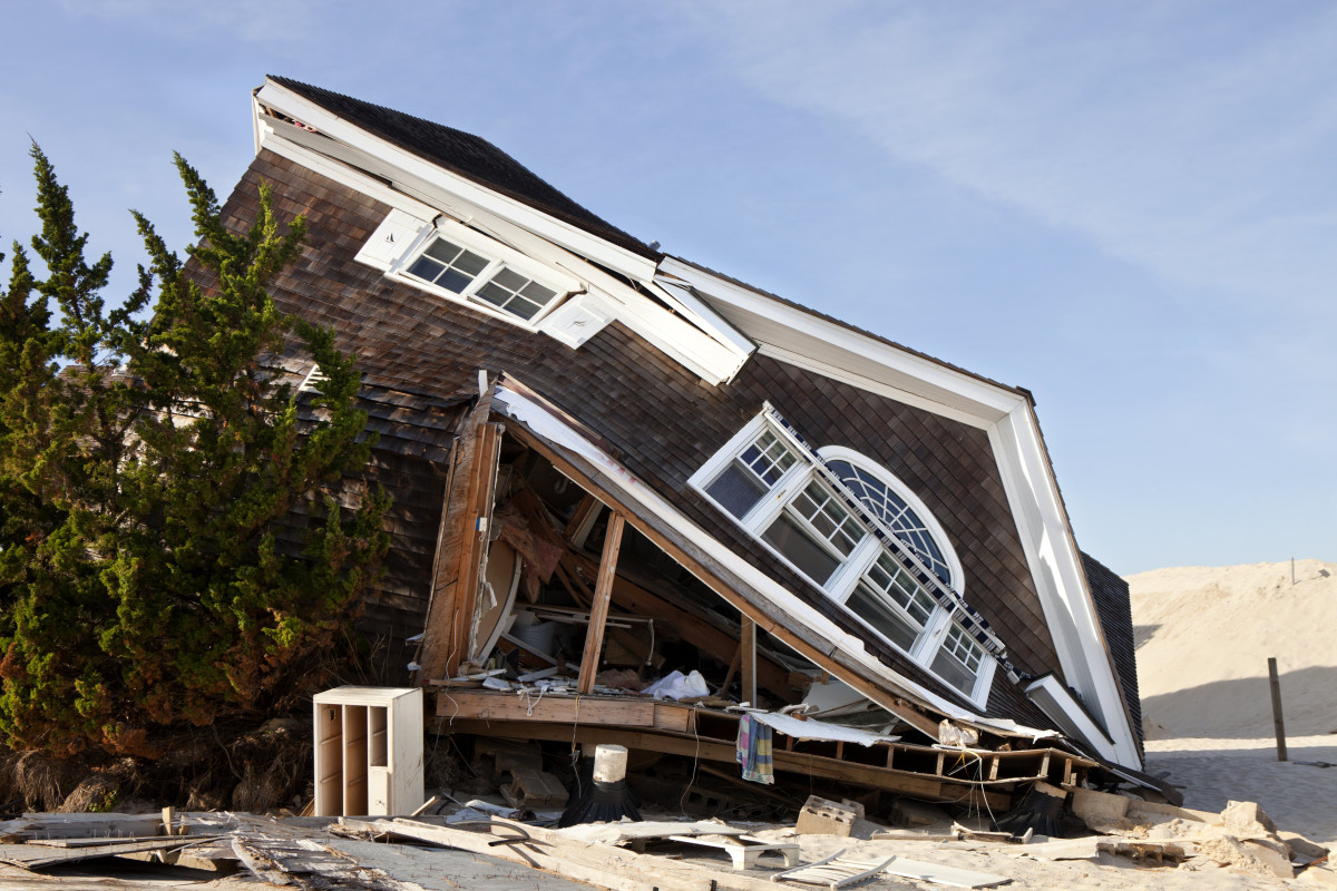 Storm damage response crew assessing structural damage to a US home after severe weather